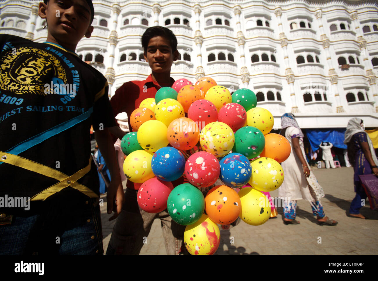 Boys selling balloons outside the Sachkhand Saheb Gurudwara in Nanded ; Maharashtra ; India NO MR Stock Photo