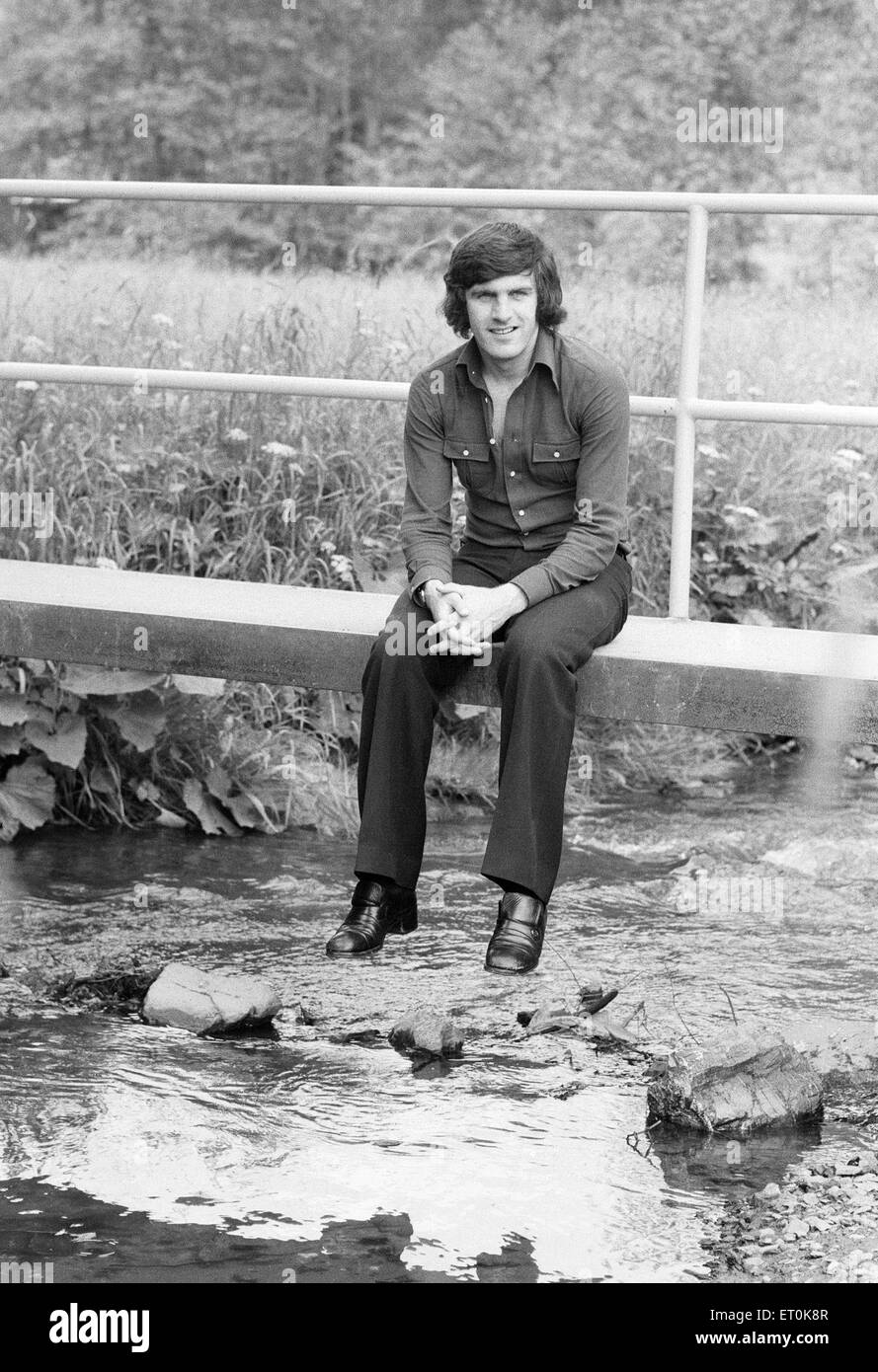 1974 World Cup tournament in West Germany. The Scotland football team relaxing at their Weilnau Hotel  in Frankfurt. Peter Lorimer sitting on a small bridge over a stream. 17th June 1974. Stock Photo