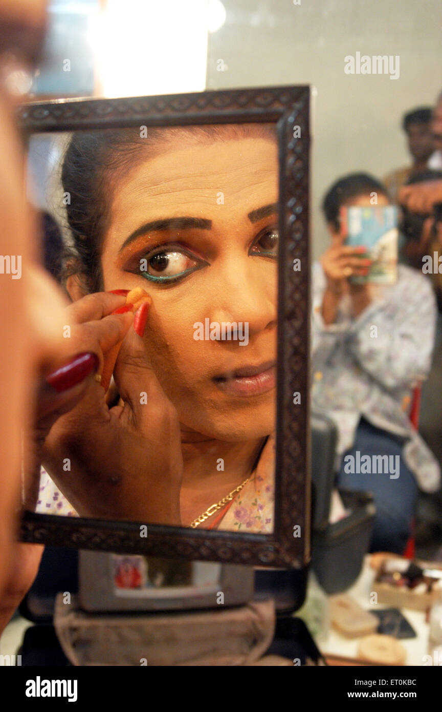 Male artist applying eye liner getting ready for show Bin Baicha Tamasha ; India NO MR Stock Photo