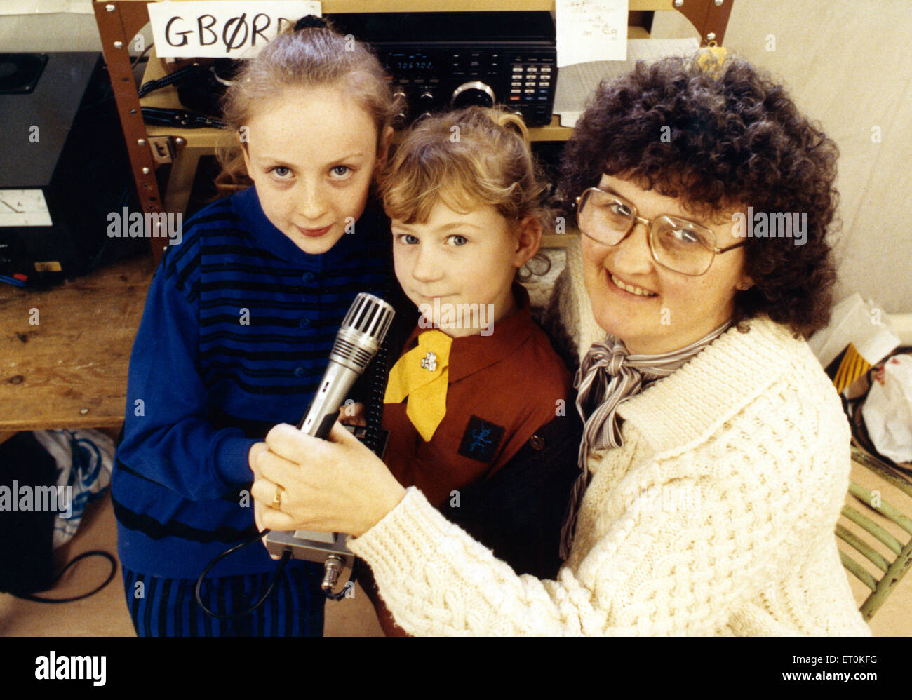 Guides and Brownies of Recar found novel way of promoting friendship when they took to the airwaves as part of their annual Thinking Day. Redcar Guide, Elizabeth Moore (left) and Brownie Leanne Lawrence are pictured with ex Guider Sylvia Burton, an amateur radio enthusiast. They took to the airwaves to contact other Guiders around the world. 2nd March 1990. Stock Photo