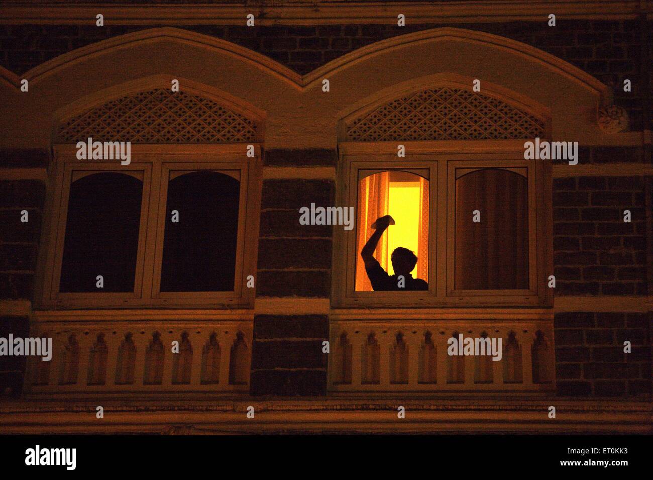 Foreign guest asking for help during terrorist attack by Deccan Mujahedeen ; Bombay Mumbai ; Maharashtra Stock Photo