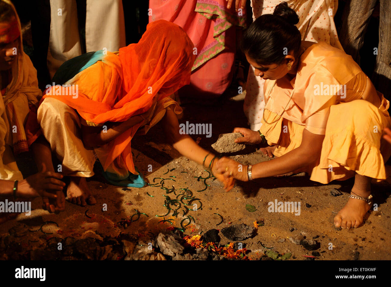 Woman breaking green bangles as mark of widowhood after wedding of eunuchs Bewa Purnima at Ghatkopar ; Mumbai Stock Photo