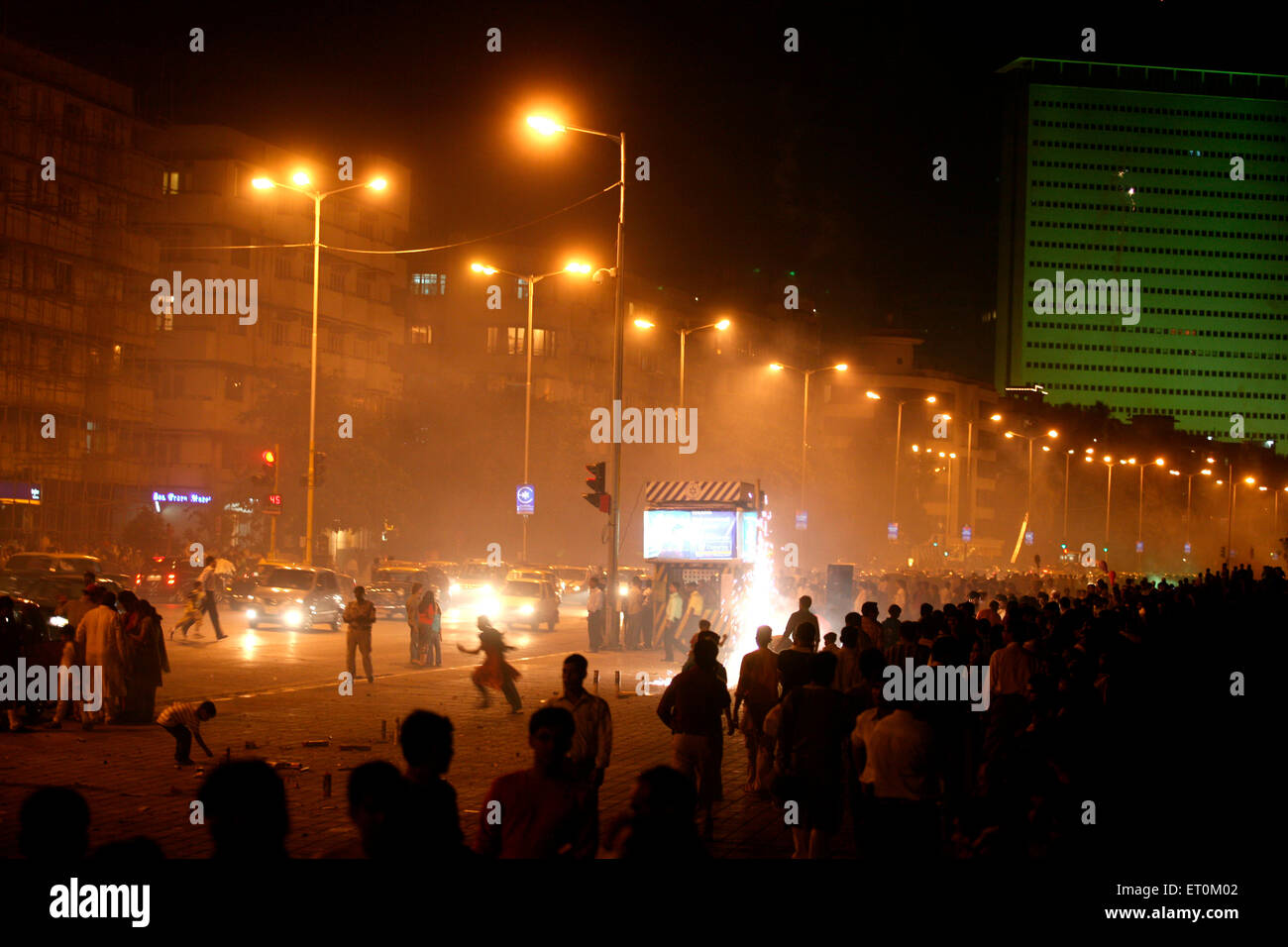 People celebrating Diwali Deepawali ; festival of lights by bursting fire crackers at Marine drive in Bombay Stock Photo