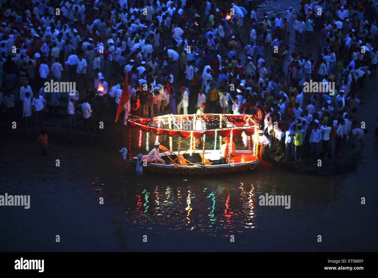 Small royal boat decorated with flowers and lights for immersion of lord Ganesh ; Sangli ; Maharashtra ; India Stock Photo