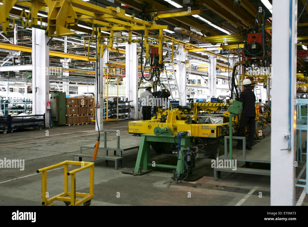 Automobile experts working in workshop ; Tata motors plant ; Pimpri near Pune ; Maharashtra ; India Stock Photo