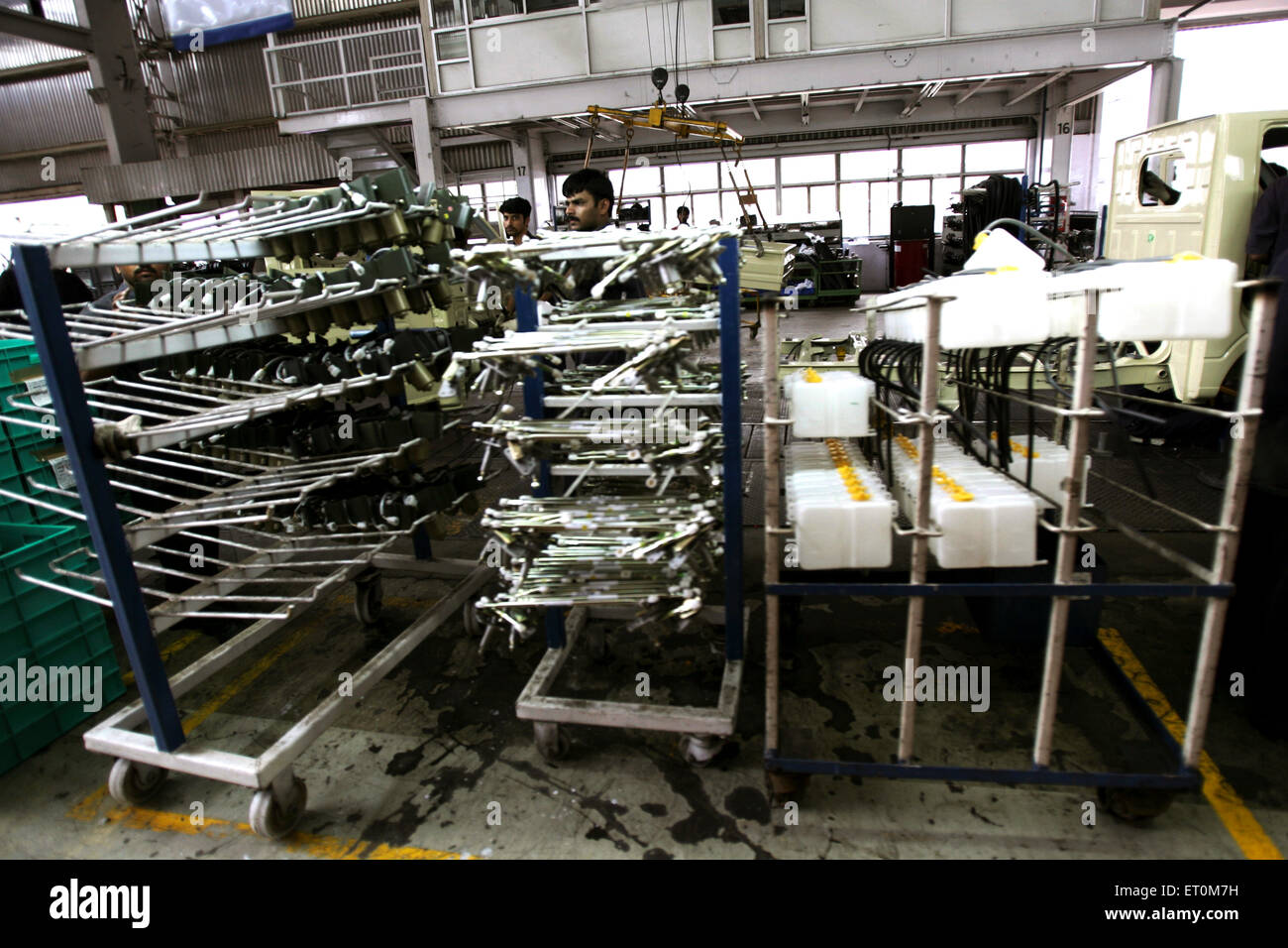 Automobile experts working in workshop ; Tata motors plant ; Pimpri near Pune ; Maharashtra ; India Stock Photo