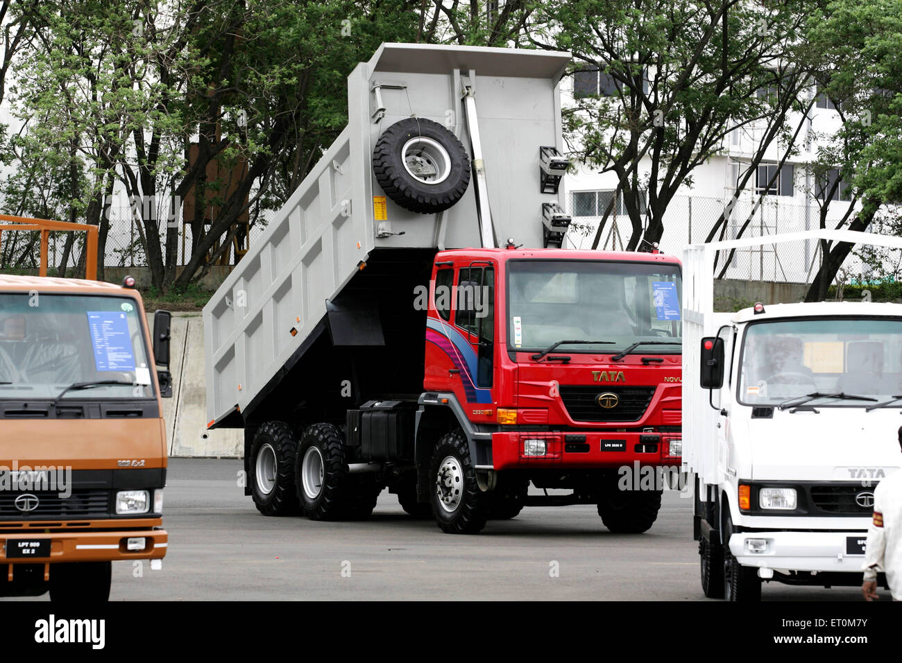 Various commercial products like matadors ; trucks parked at Tata motors plant ; Pimpri near Pune ; Maharashtra ; India Stock Photo