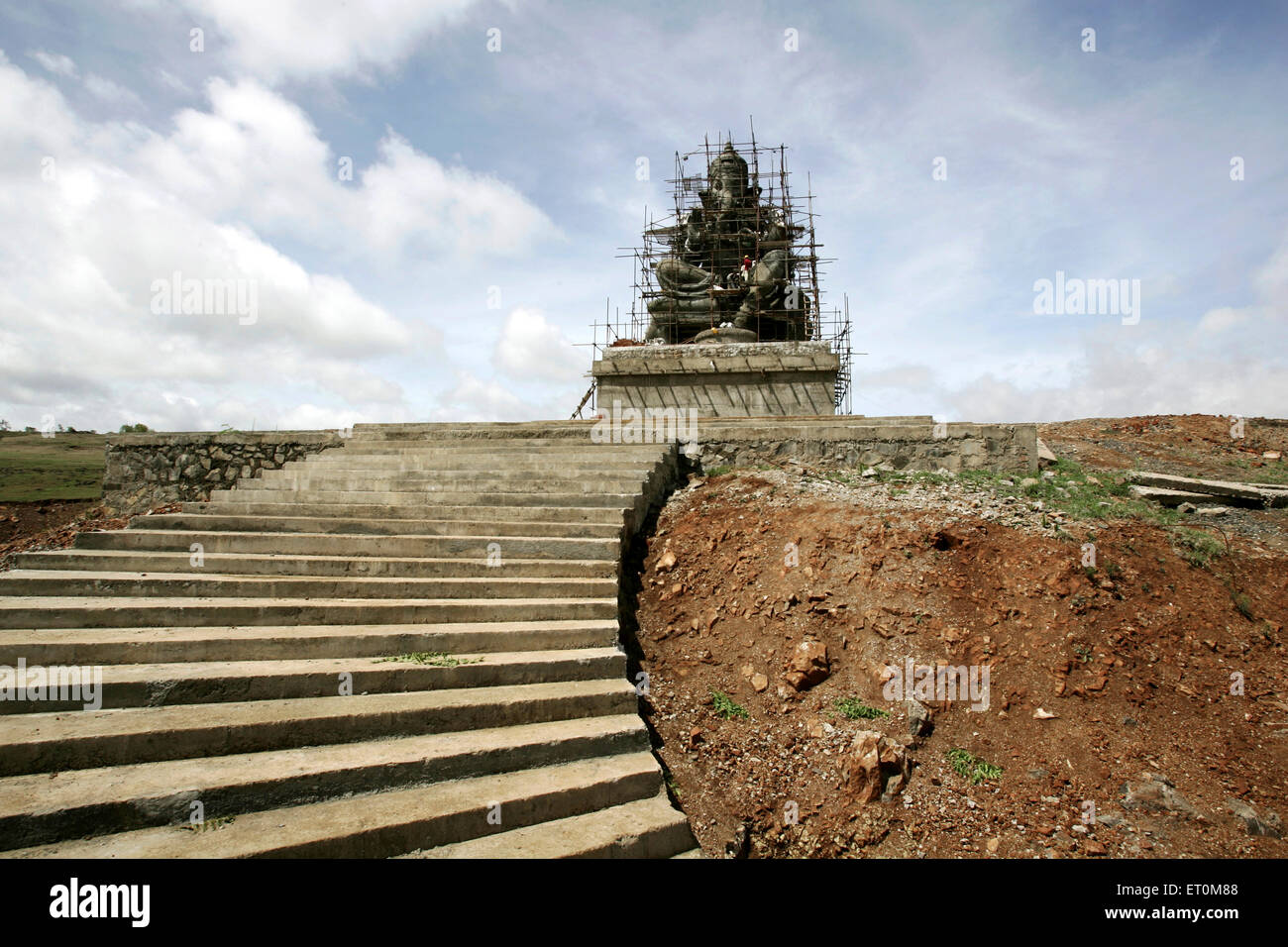 Stairs leading to huge statue of lord Ganesha elephant headed god erected on highway Mumbai Pune  ; Maharashtra ; India Stock Photo