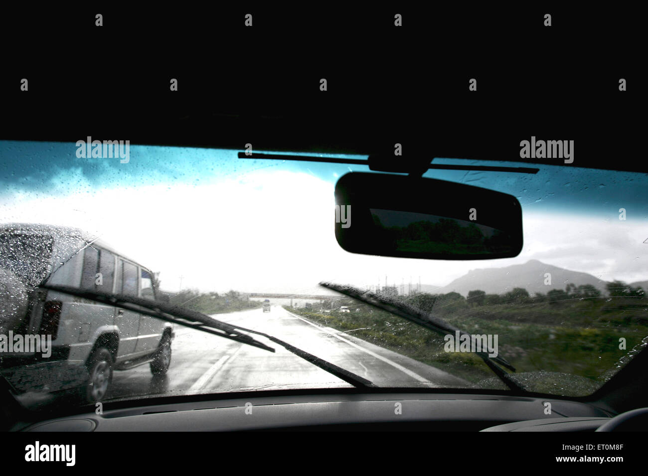 Car wipers wiping front glass on the Expressway between Mumbai Pune  ; Maharashtra ; India Stock Photo