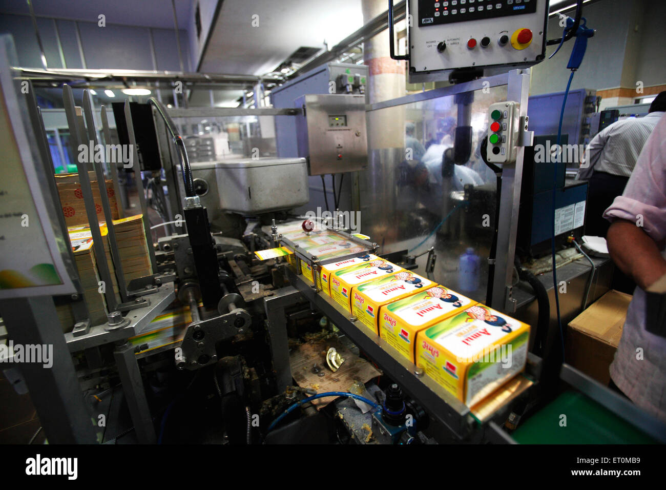 Amul butter packed in wrappers on conveyor belt in Amul factory in Anand Gujarat India Indian butter factory Stock Photo
