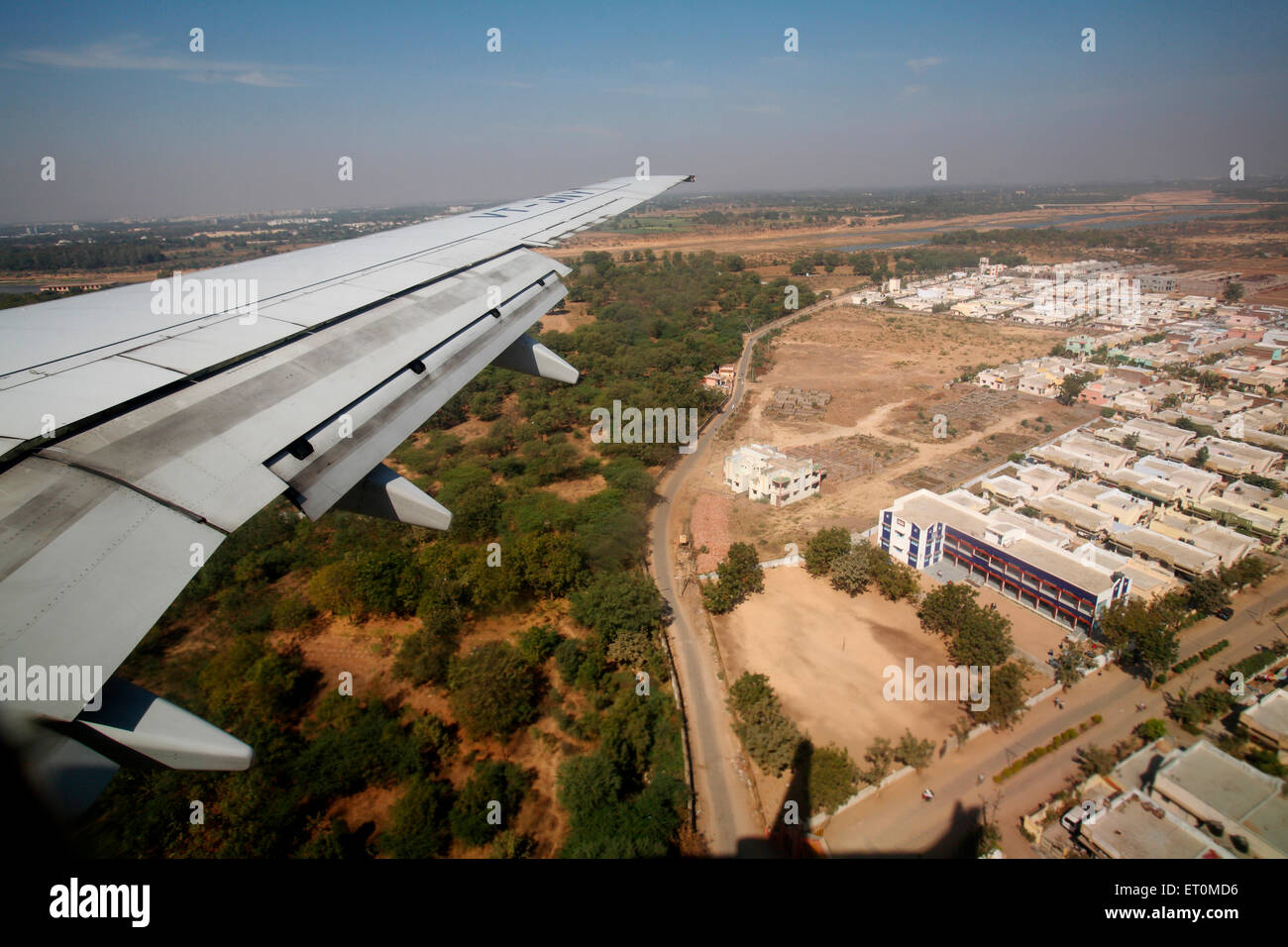 Wing of aircraft flying over city of Ahmedabad ; Gujarat ; India Stock Photo