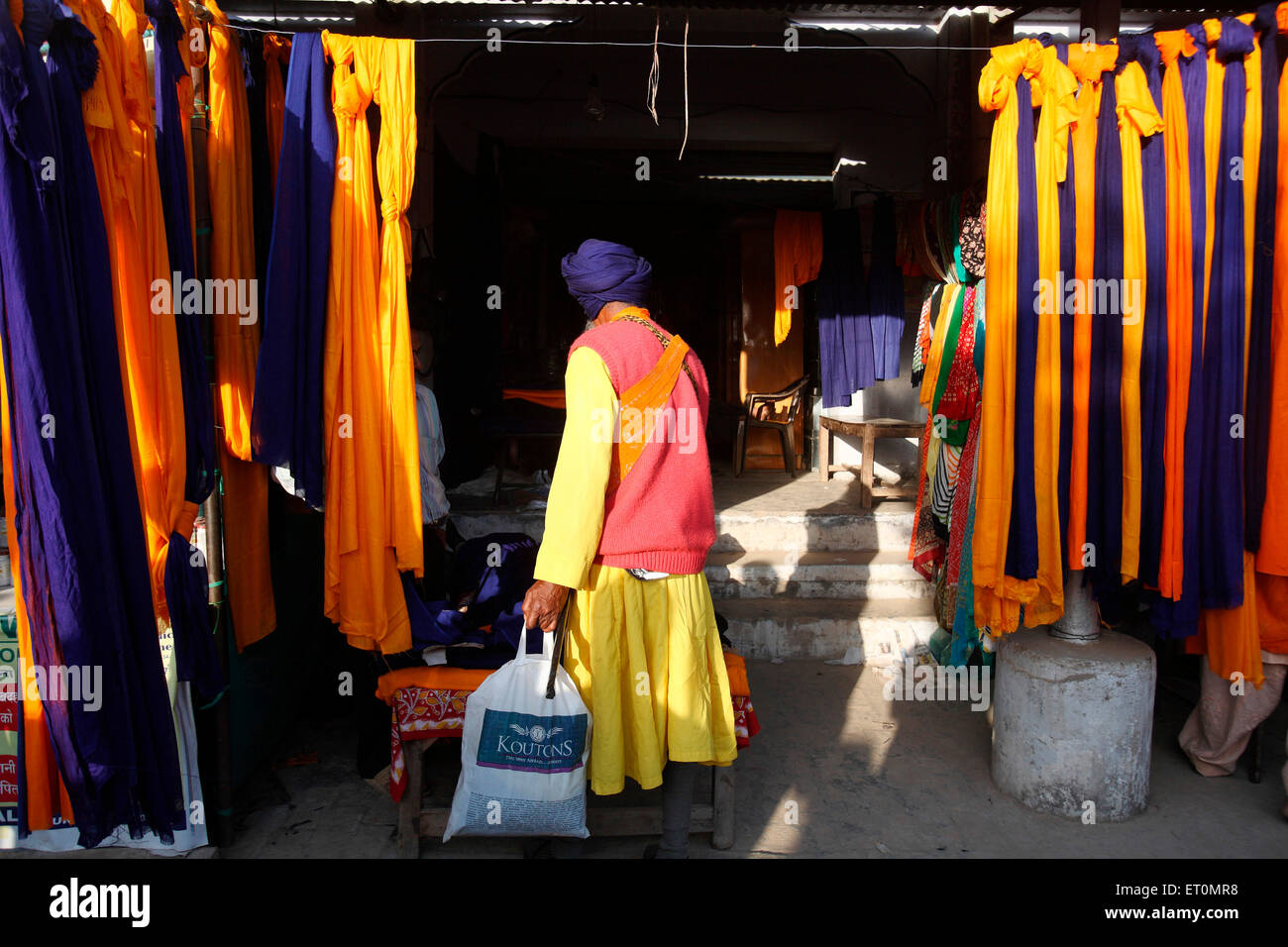 Nihang  or Sikh warrior buying clothes during the celebrations of Hola Mohalla at Anandpur sahib in Rupnagar Stock Photo