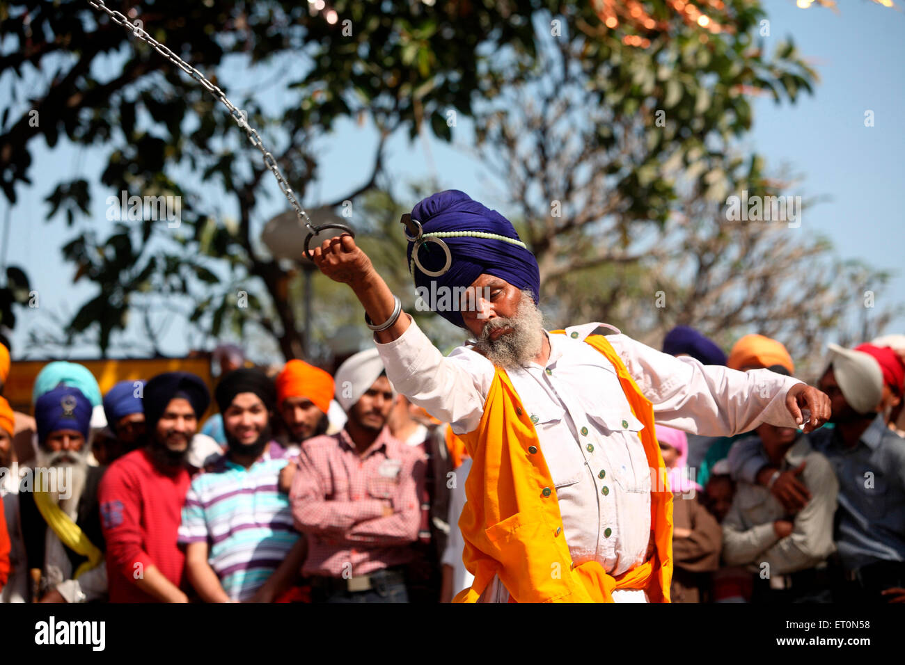 Nihang or Sikh warrior performing stunts with chain in during Hola Mohalla celebrations at Anandpur sahib Stock Photo