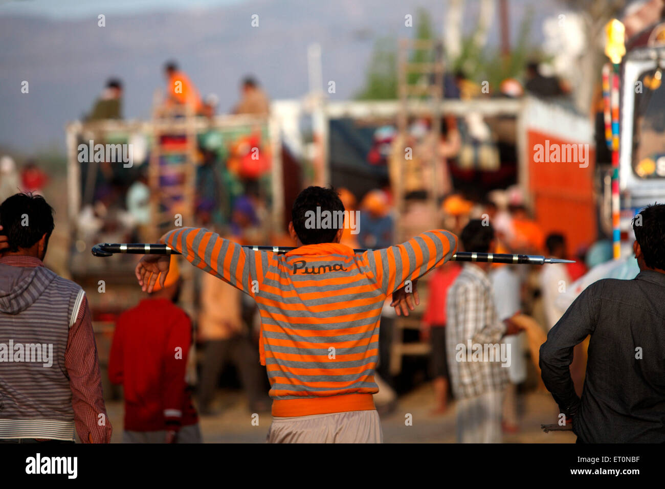 Devotee carrying spear on his shoulders during Hola Mohalla celebration in Anandpur sahib in Rupnagar district ; Punjab ; India Stock Photo
