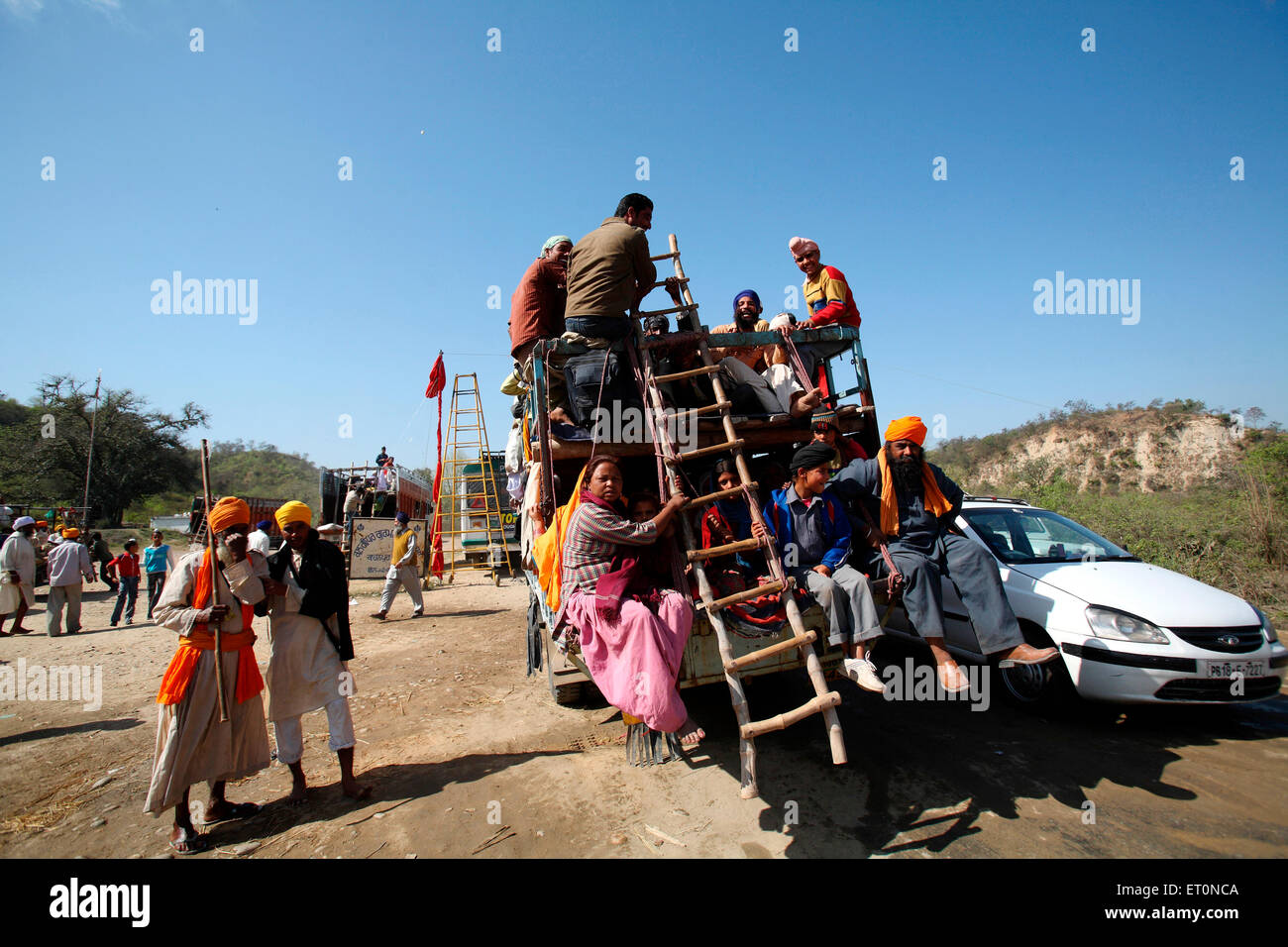 People travelling sitting on truck in Punjab ;  India Stock Photo