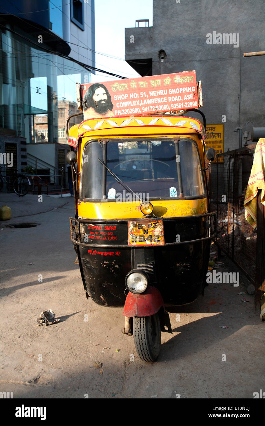 Auto rickshaw carrying advertising message, Amritsar, Punjab, India Stock Photo
