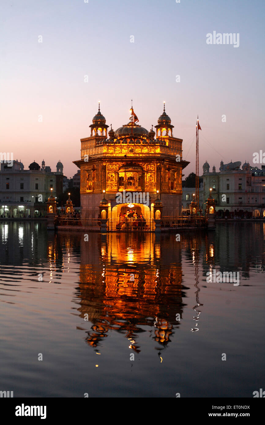 Glow of Harmandir Sahib or Darbar Sahib or Golden temple reflection in lake in Amritsar ; Punjab ; India Stock Photo
