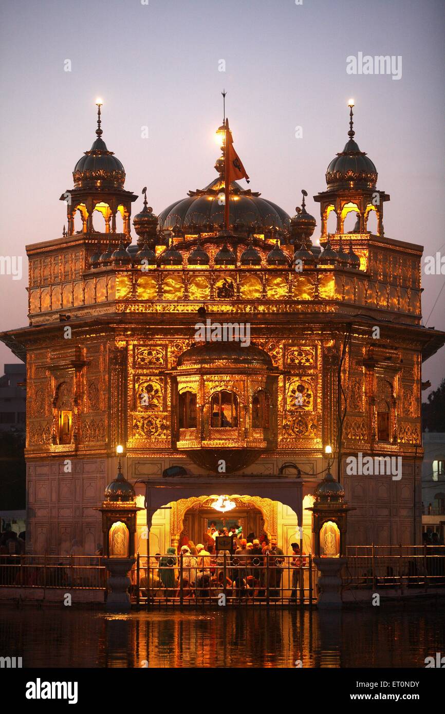 Glow of Harmandir Sahib or Darbar Sahib or Golden temple reflection in lake in Amritsar ; Punjab ; India Stock Photo
