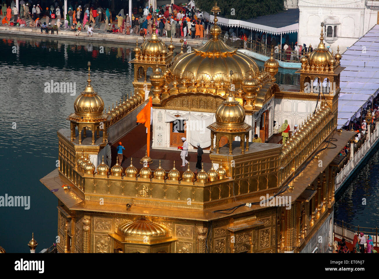 Close view of top of Harmandir Sahib or Darbar Sahib or Golden temple surrounded by lake in Amritsar ; Punjab ; India Stock Photo