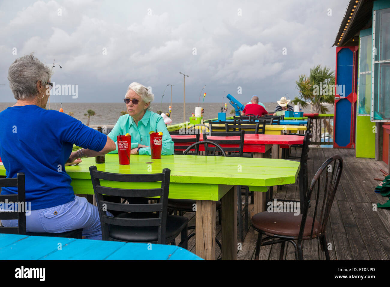 Pass Christian, Mississippi - Outdoor dining as a storm approaches at Shaggy's Pass Harbor Restaurant on the Gulf of Mexico. Stock Photo
