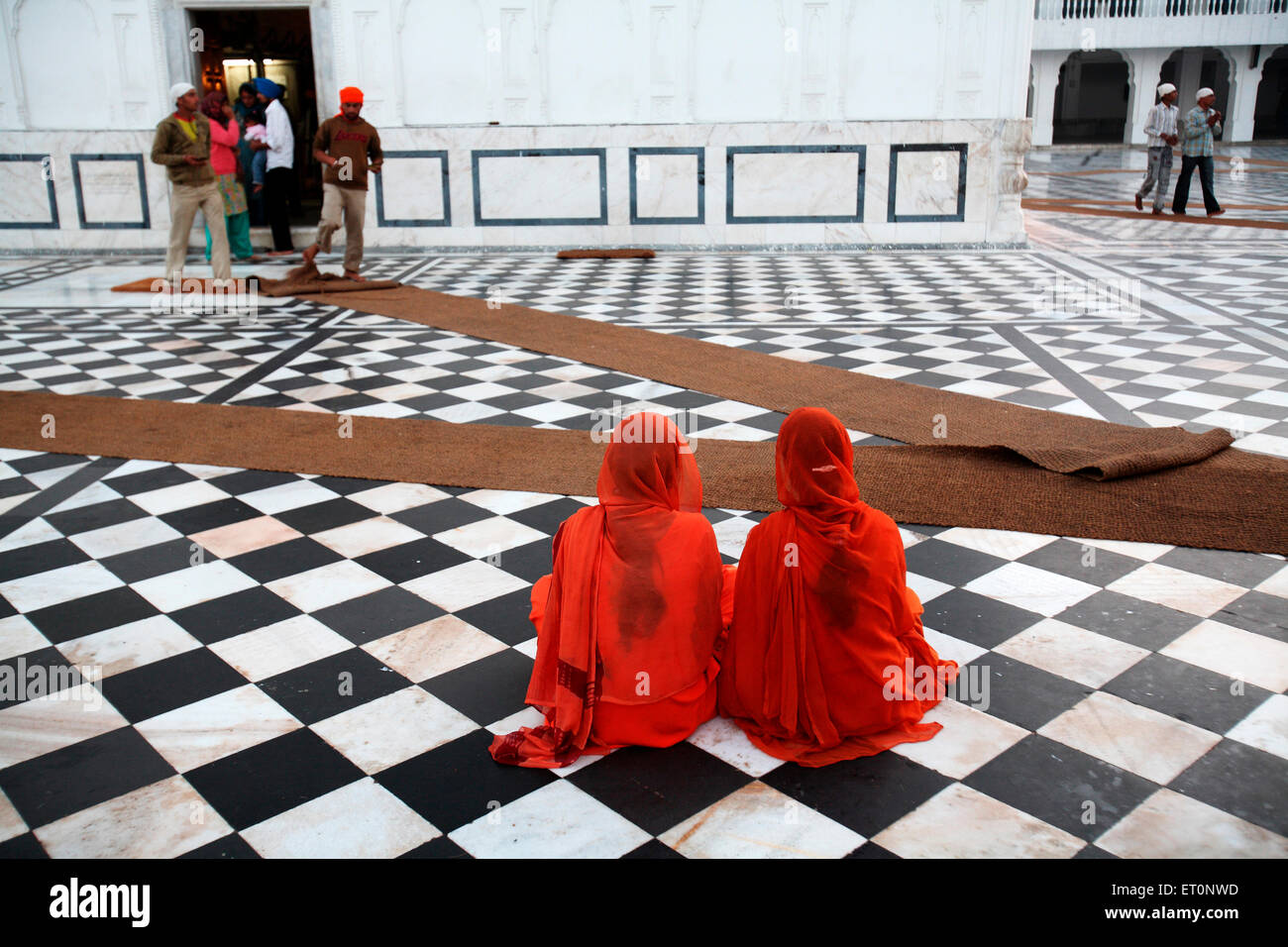Girls sitting at Guru Tegh Bahadur sahib Gurudwara at Baba Bakala  ; Amritsar  ; Punjab  ; India Stock Photo
