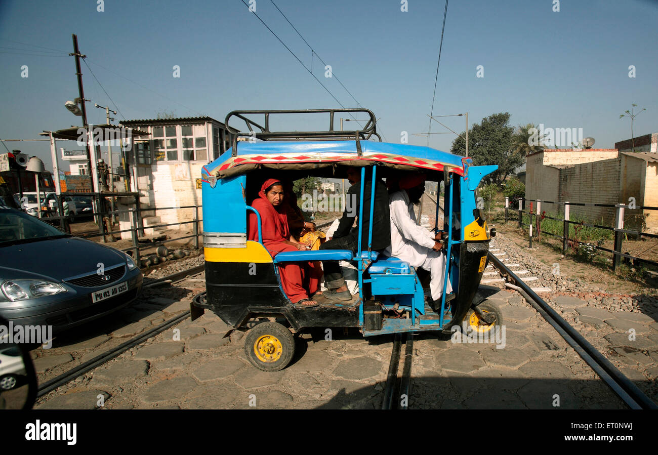 Vehicles passing through railway crossing in Punjab  ; India Stock Photo