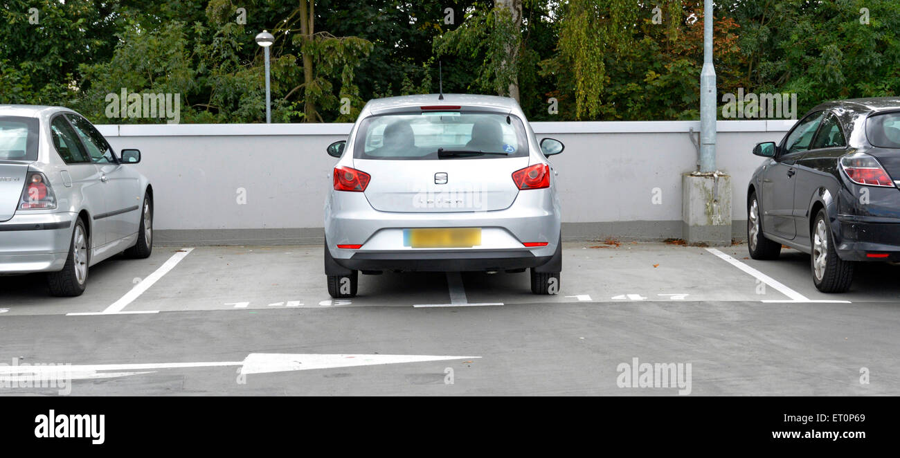 Bad inconsiderate parking, (or a good reason?) at roof level in a full pay and display multi storey public car park at a NHS hospital Essex England UK Stock Photo