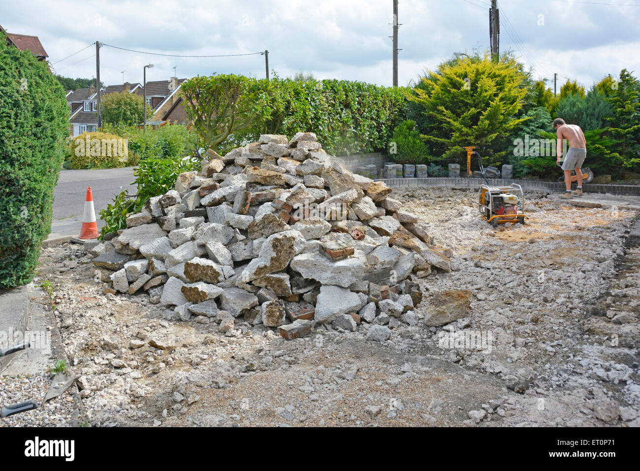 Front garden of residential property having concrete driveway broken up ready for new block paving Stock Photo