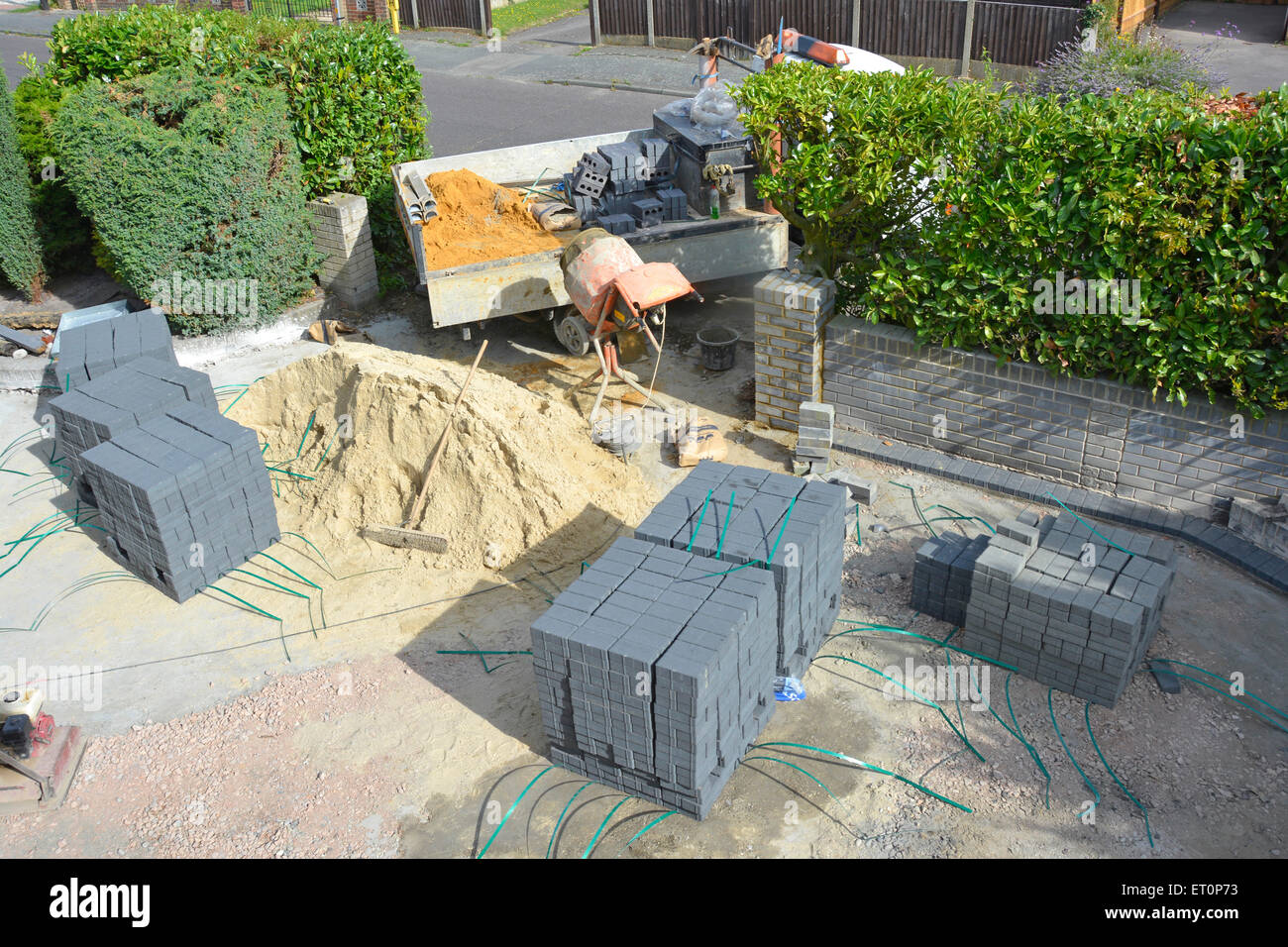 Sand and paving blocks in front garden of residential property creating