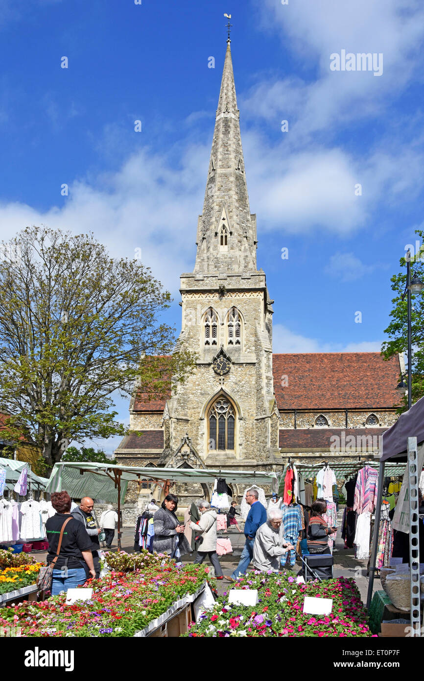 Market stall selling plants in Romford market with spire of Saint