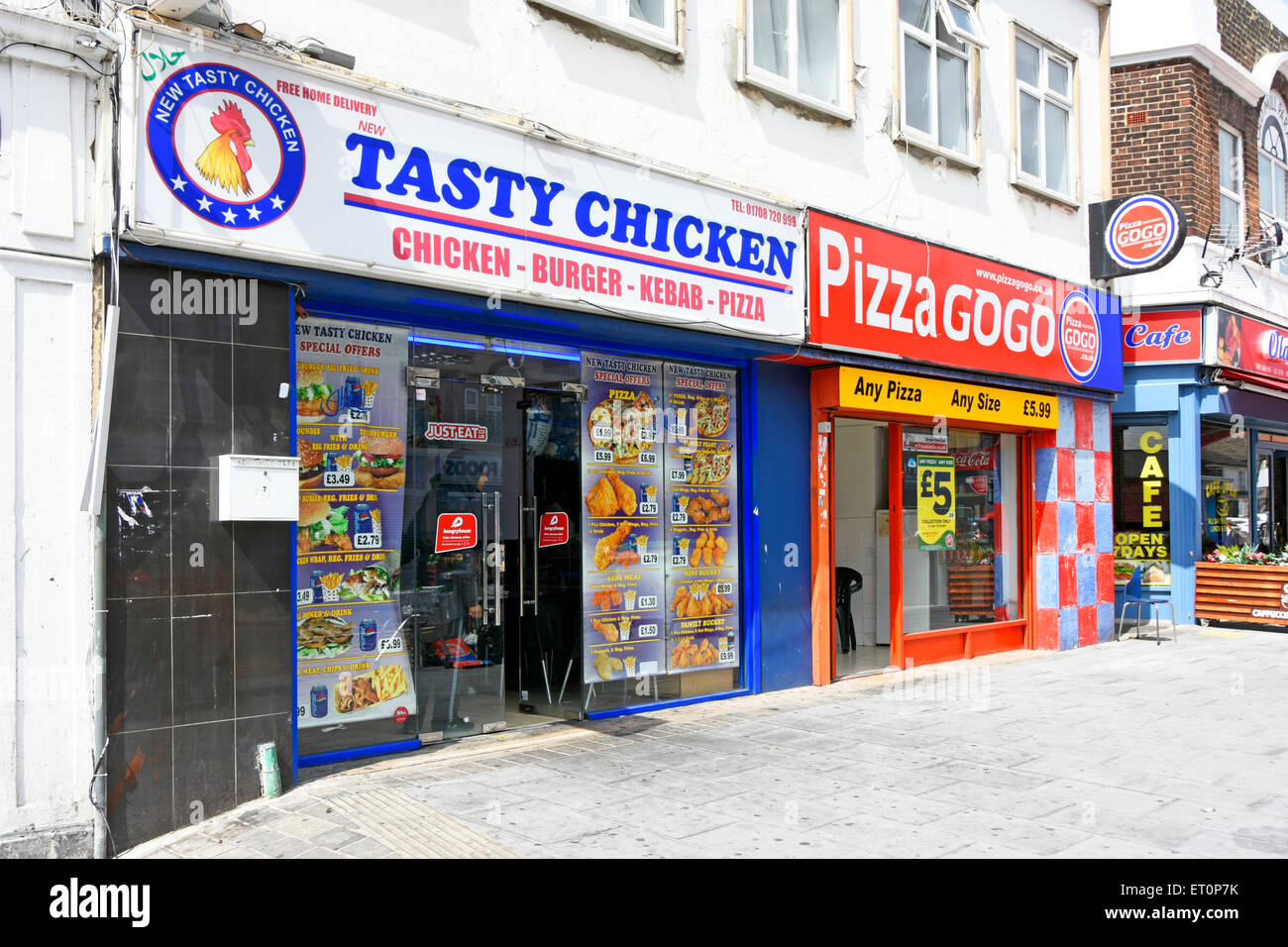 Chicken Pizza and Cafe independent retail street scene businesses shop front premises in competition next each other in Romford East London England UK Stock Photo