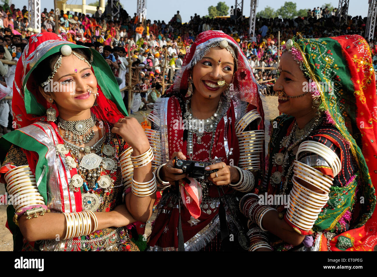 Girls in traditional jewellery and rajasthani costume having chat with