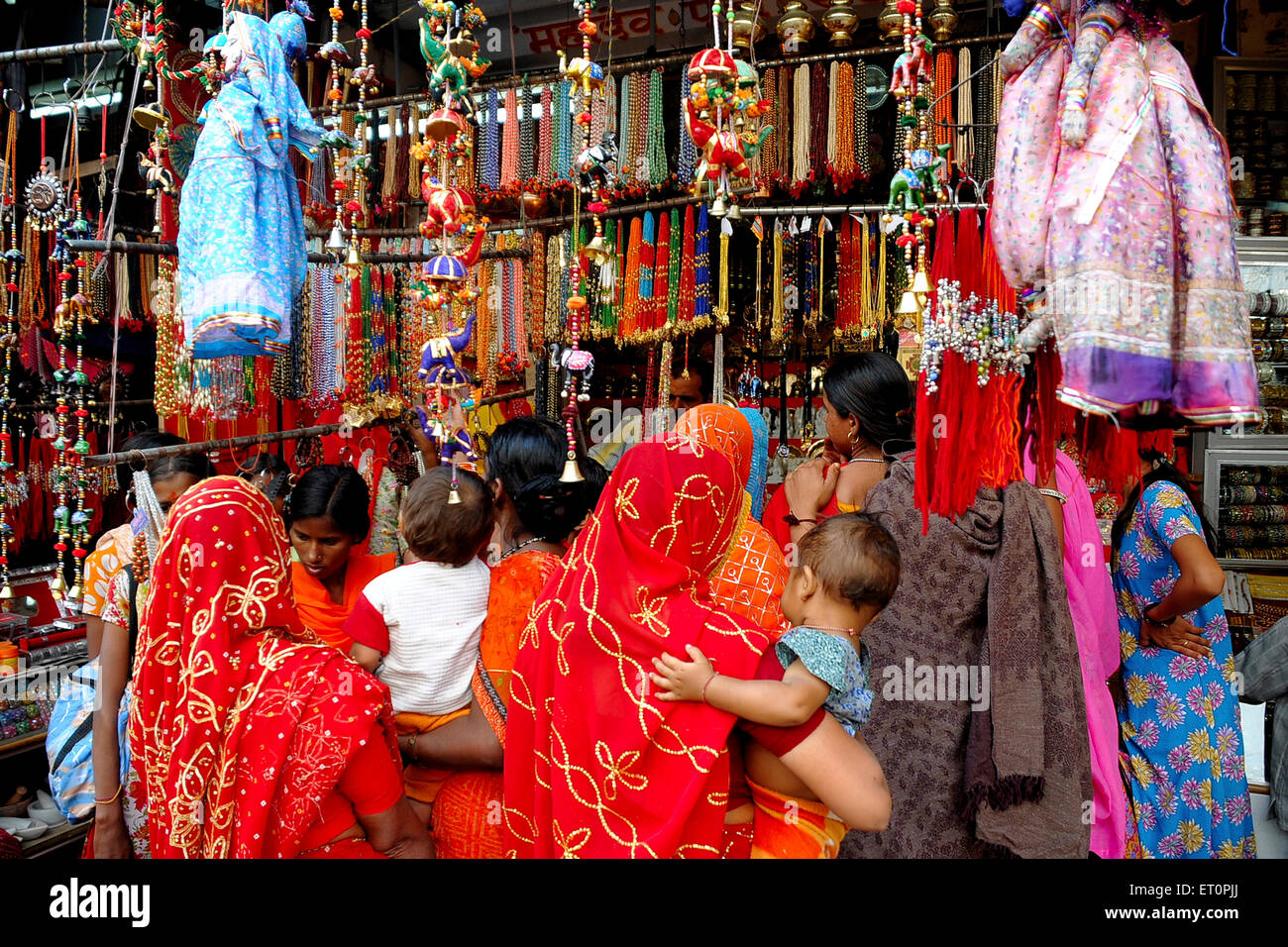 Rajasthani ladies shopping at shop in Pushkar fair ; Rajasthan ; India
