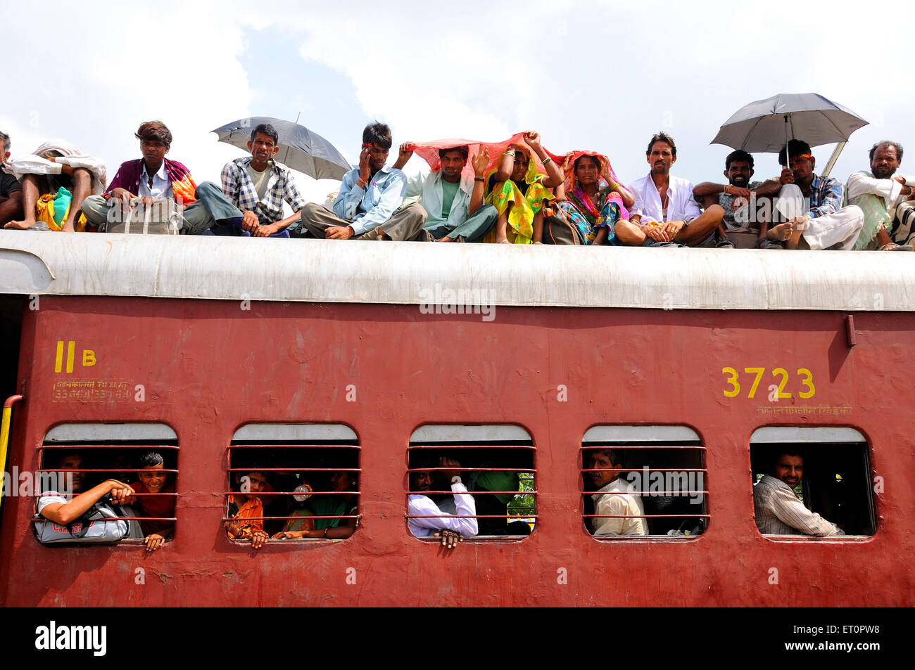 People taking risk while travelling on roof of train ; Goram ghat ; Marwar Junction ; Rajasthan ; India Stock Photo