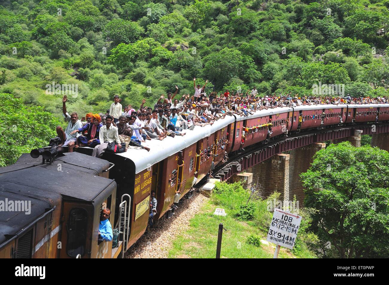 People traveling crowded on roof of train risky dangerous railway travel Jodhpur Rajasthan India Asia Asian Indian Stock Photo