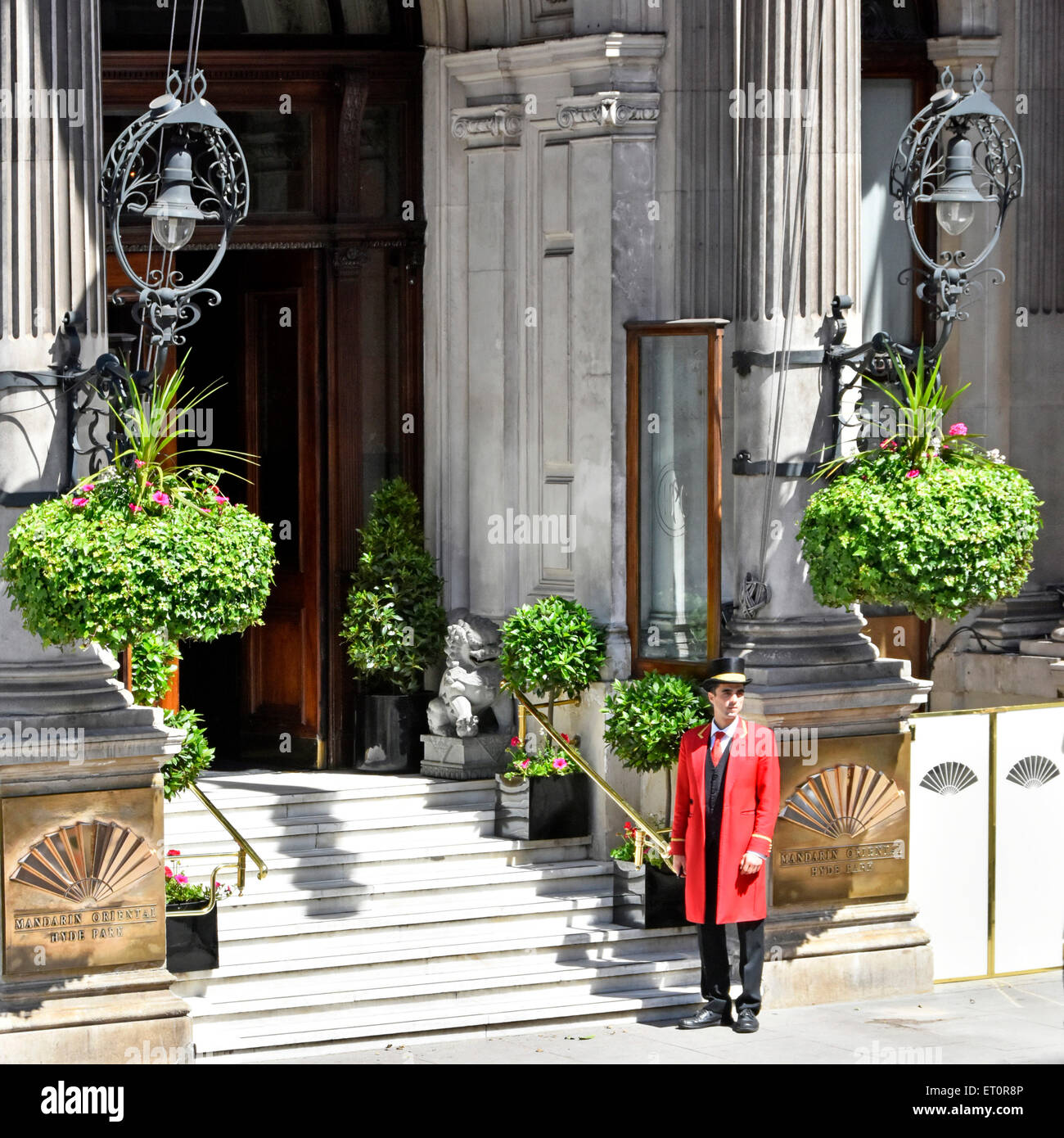 Knightsbridge one doorman in uniform outside the ornate entrance & steps to five star luxury Mandarin Oriental Hotel Hyde Park London England UK Stock Photo