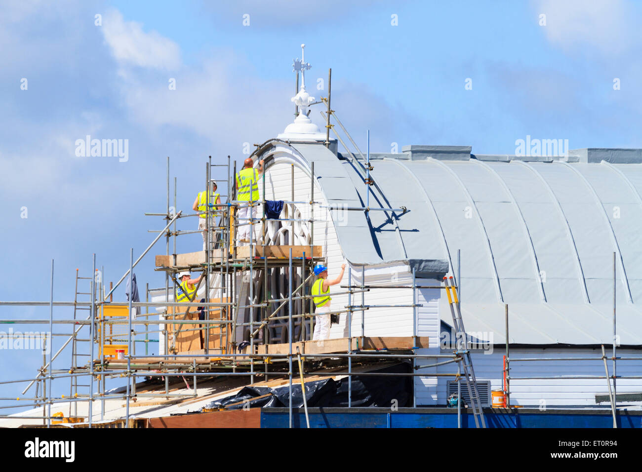 Building decorators put finishing coats of paint on Cleethorpes Pier