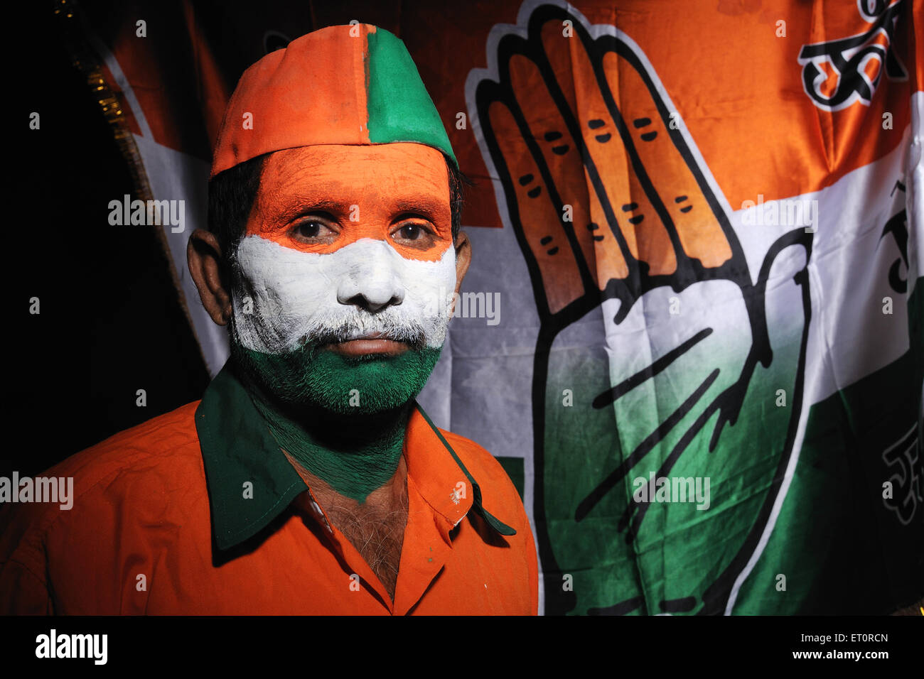 Indian flag of India painted on face and Congress party flag India MR#769B Stock Photo
