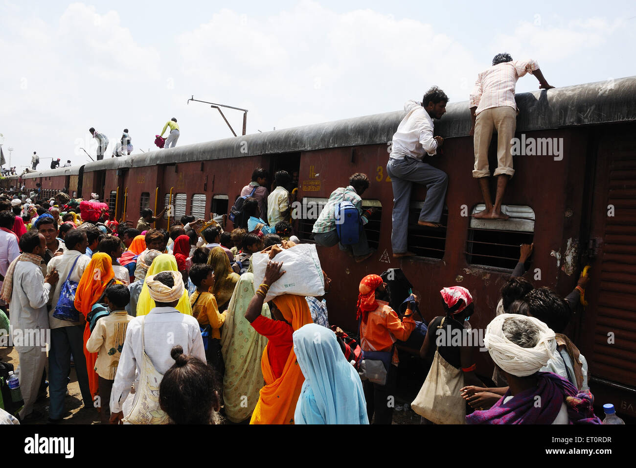 Commuters climbing on roof of train ; Jodhpur ; Rajasthan ; India Stock Photo