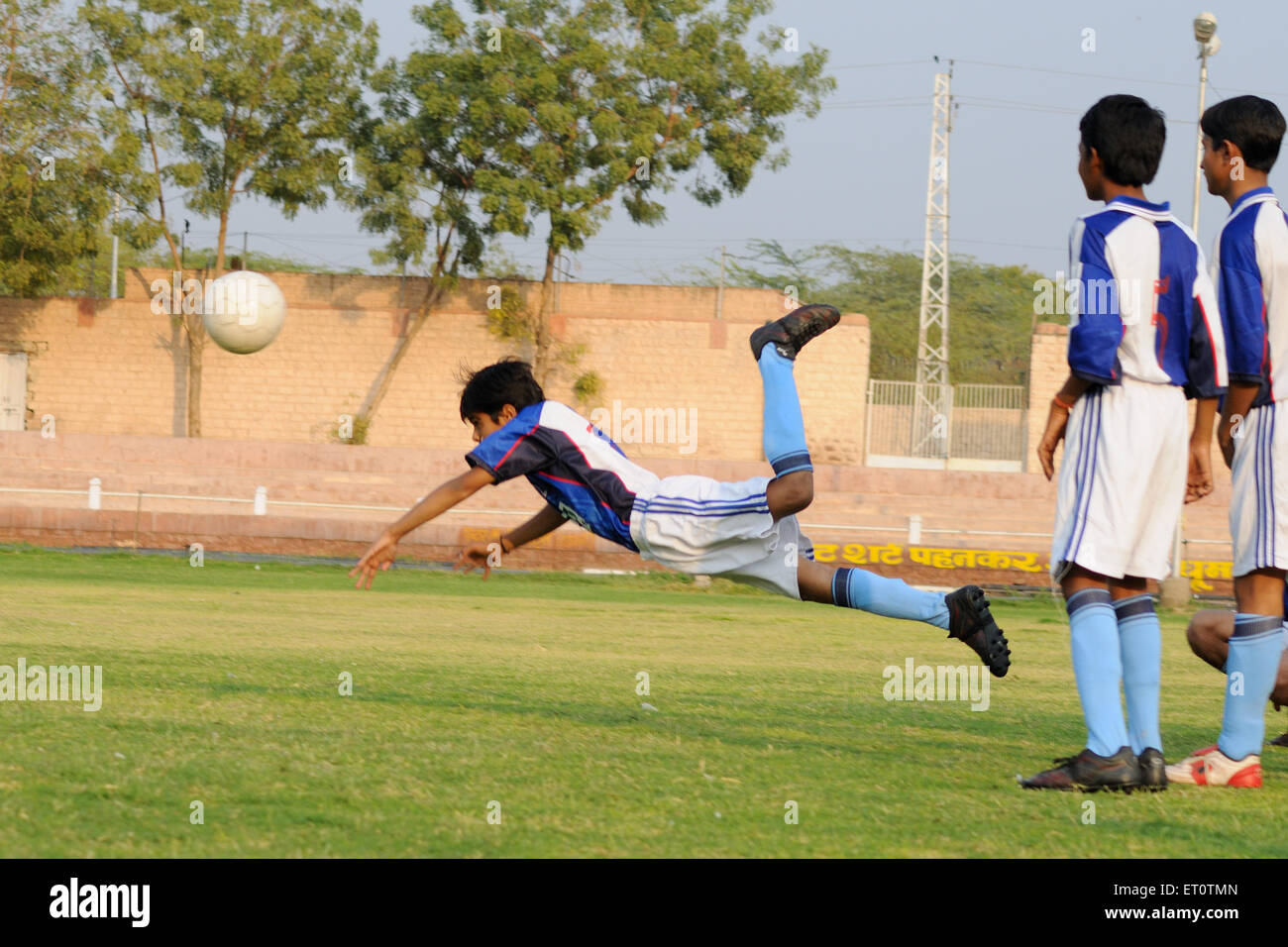 Indian teenagers playing football hires stock photography and images