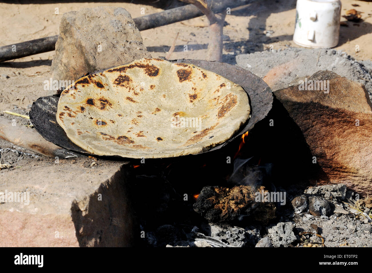 Indian Rajasthani food roti bread cooking on a pan ; Jodhpur ; Rajasthan ; India Stock Photo