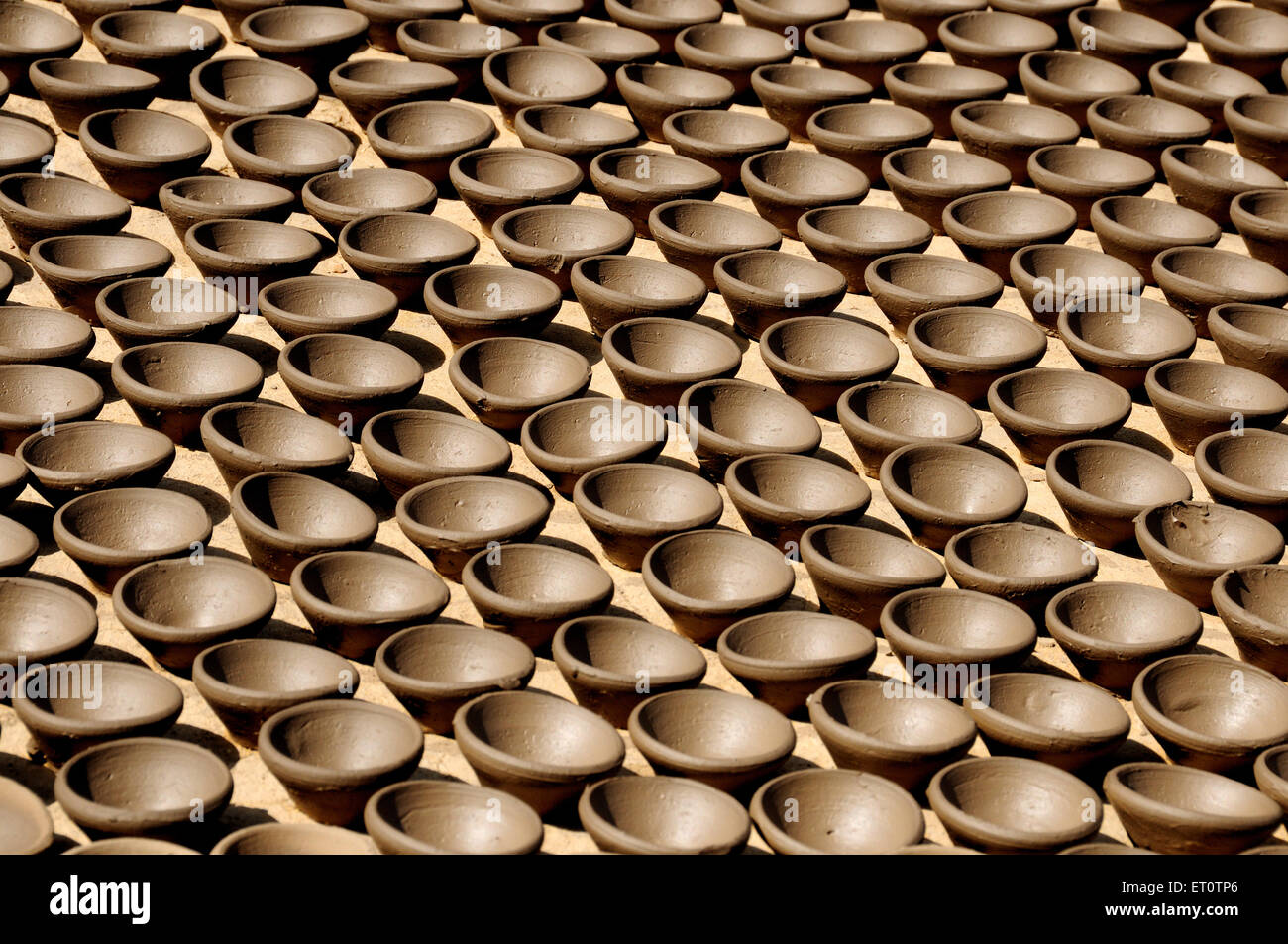 Oil lamps in a row ; Rajasthan ; India Stock Photo