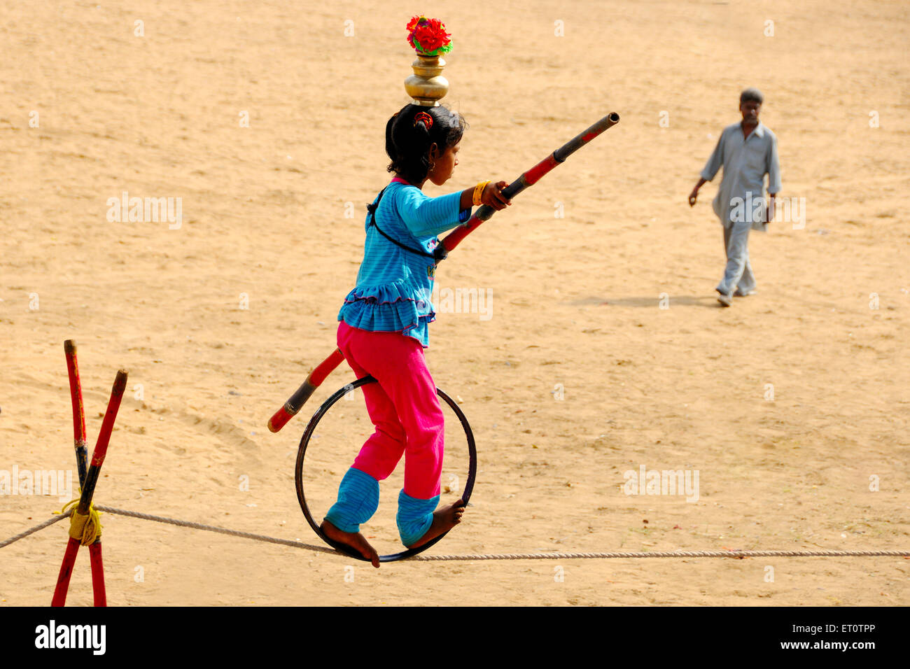 Girl showing acrobatics on a rope at pushkar fair ; Rajasthan ; India MR#786 Stock Photo