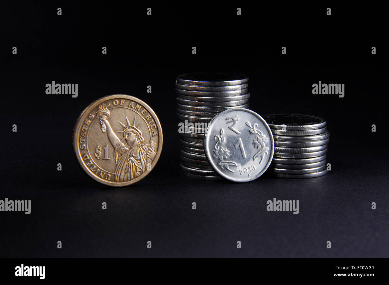 concept of Indian Rupee and American Dollar coins Stock Photo
