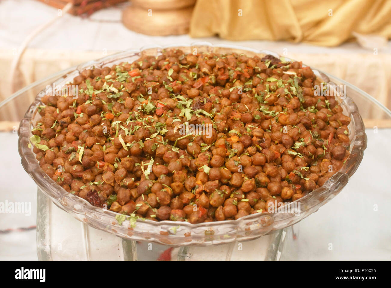 Boiled spicy chana gram kept in glass bowl ; buffet lunch arrangement for marriage ceremony party ; Bombay Mumbai ; Maharashtra Stock Photo