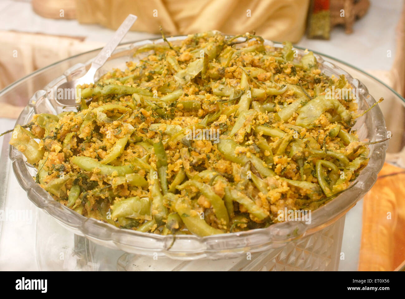 Green spicy chillies kept in glass bowl ; buffet lunch arrangement for marriage ceremony party ; Bombay Mumbai ; Maharashtra Stock Photo