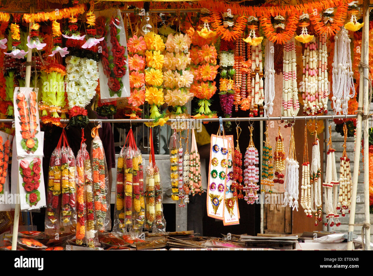 Colourful garlands artificial flowers beads pearls decorate idols of lord Ganesh ; Ganapati festival ; Dadar ; Bombay Mumbai Stock Photo