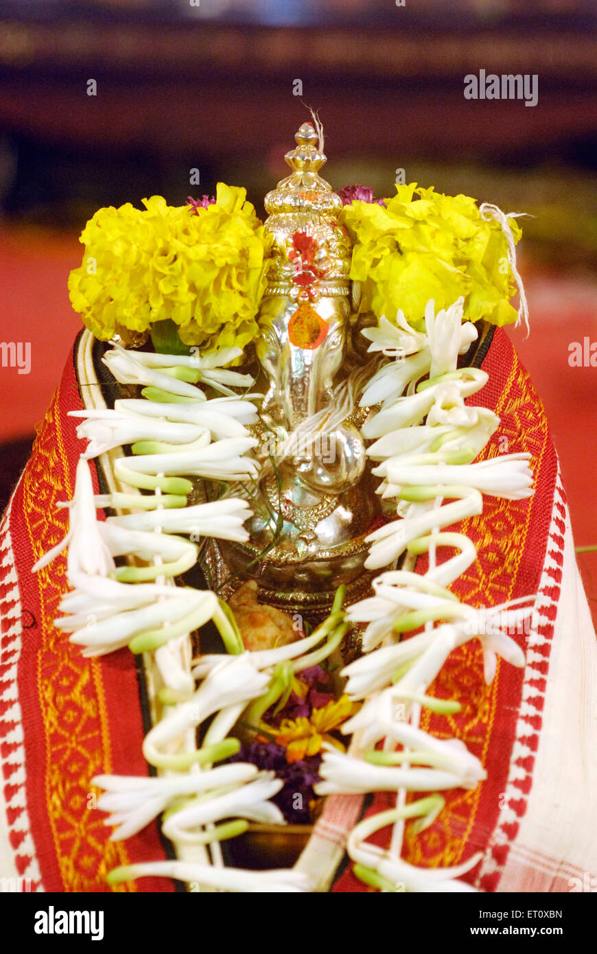 Richly decorated silver metal idol of lord Ganesh elephant headed God ; Ganapati festival year 2008 at Pune Stock Photo