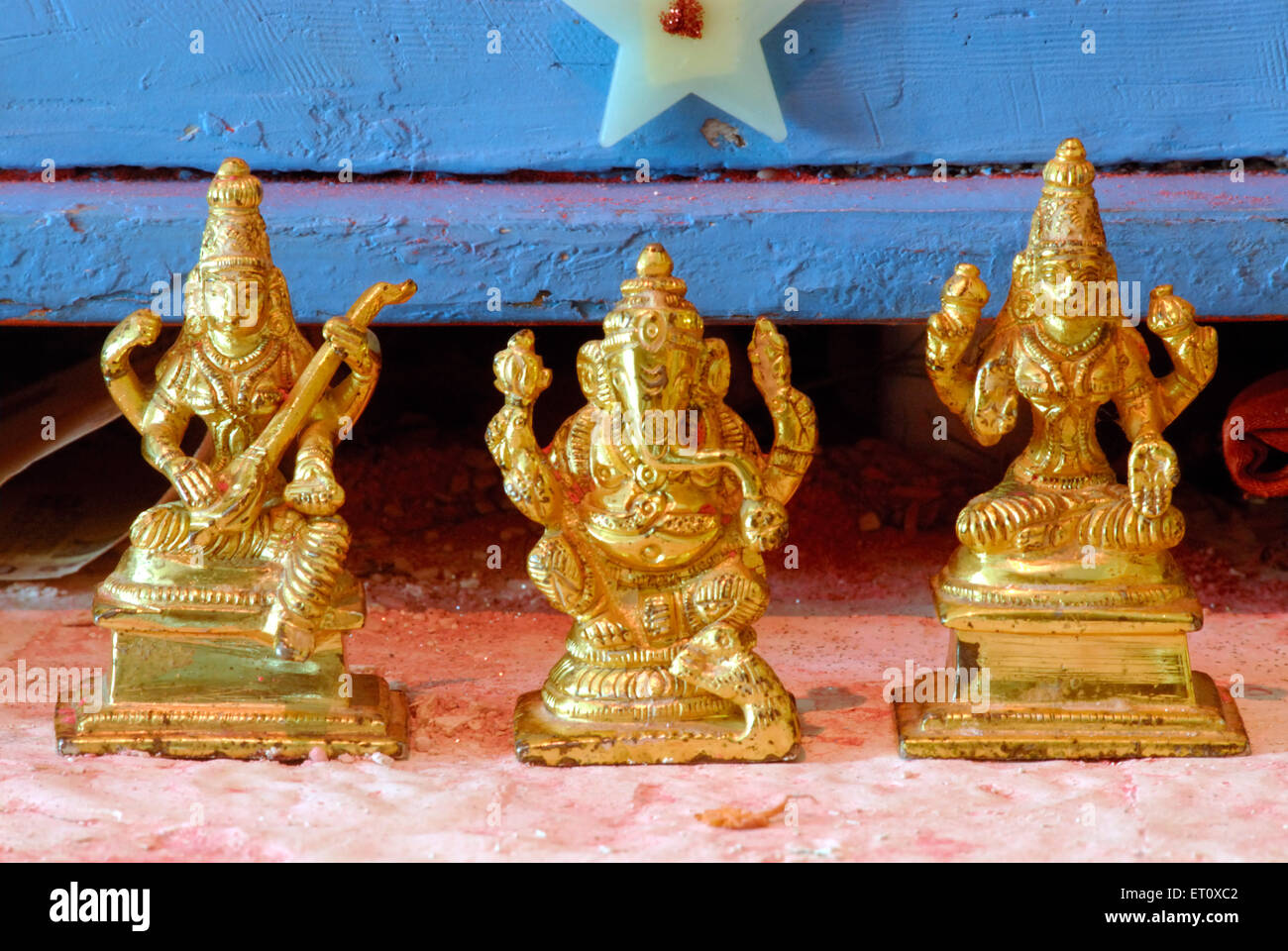 Gold plated statues of lord Ganesh ; goddess Saraswati and Laxmi at Bombay Mumbai ; Maharashtra ; India Stock Photo