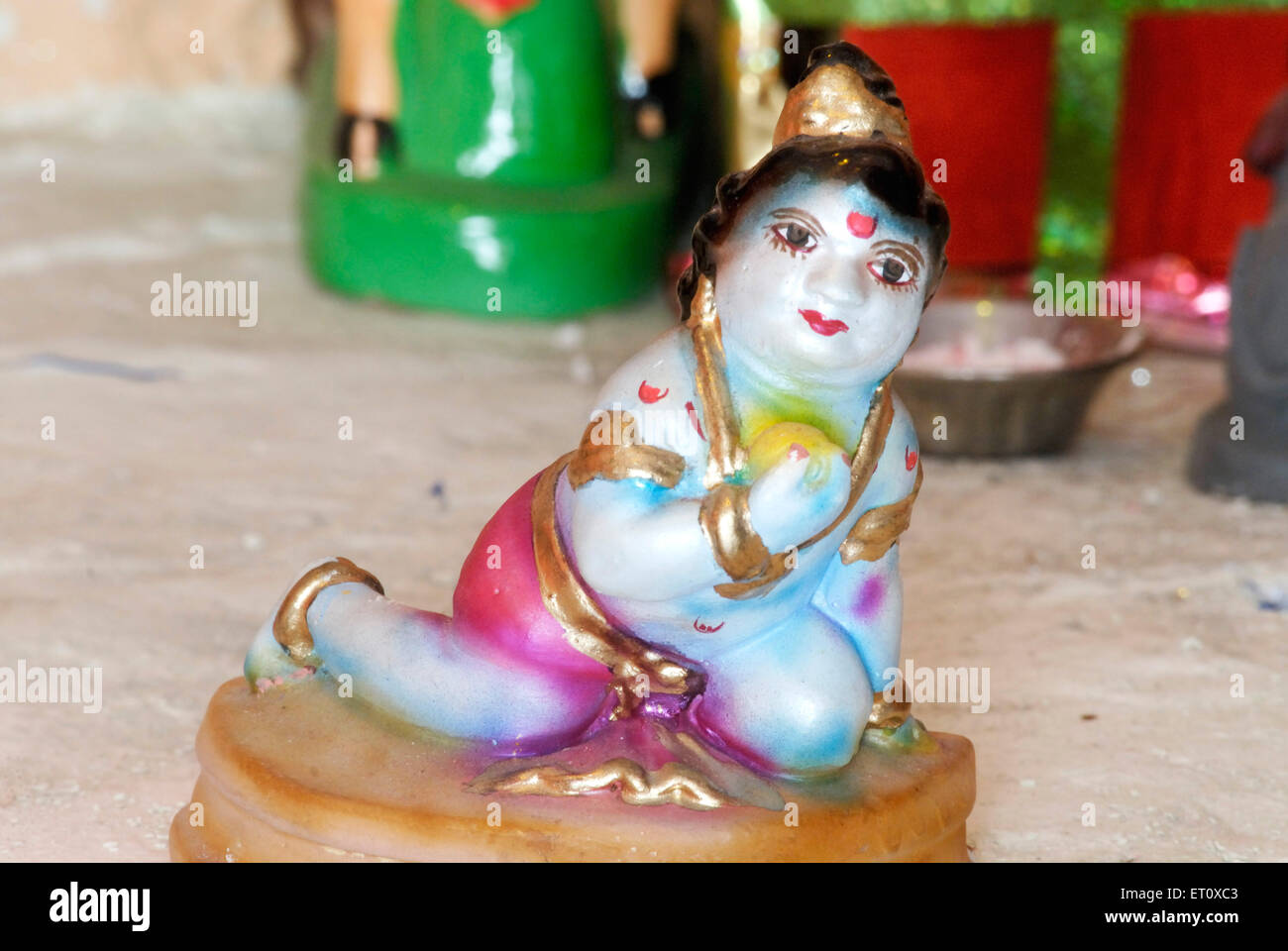Colourful idol of infant child lord Krishna eating ladu ; Bombay Mumbai ;  Maharashtra ; India Stock Photo - Alamy
